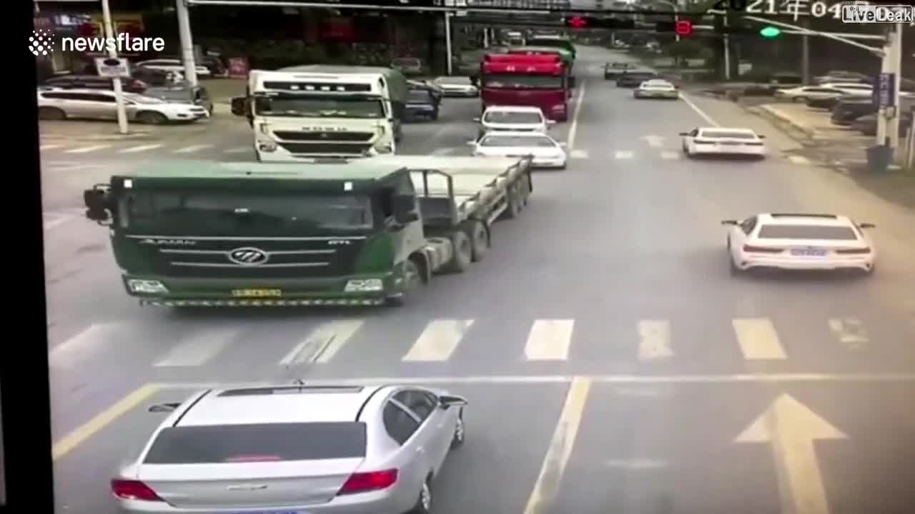 ELDERLY CHINESE MAN NARROWLY AVOIDS BEING RUN OVER BY TRUCK