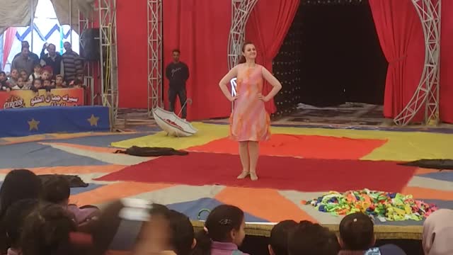 A circus model who changes her clothes on stage with amazing speed