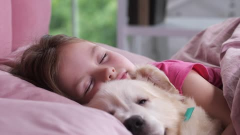 Young girl taking snap with her puppy