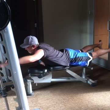 Guy dad blue shorts hat gym practicing surf paddle standing up