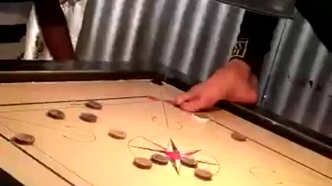 Handicap person without both the hands playing carrom