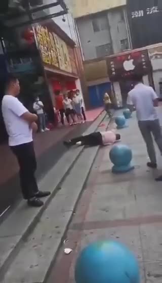 China: A man is dying in middle of street and no one is helping him - Just Videoing