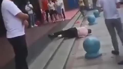 China: A man is dying in middle of street and no one is helping him - Just Videoing