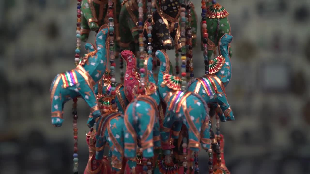 Collection of elephant trinkets sway in a traditional market in Tel Aviv