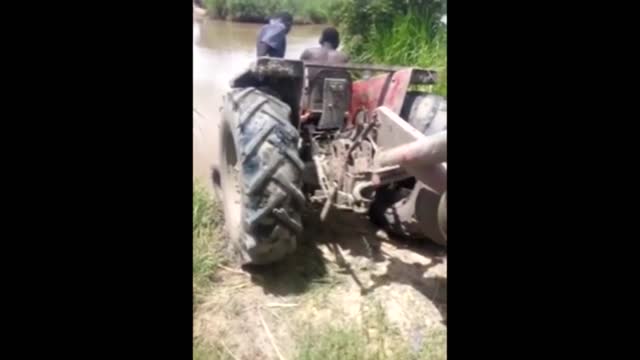 A tractor is driven to a river without special equipment caught on cam.