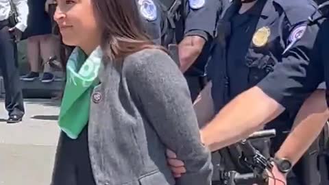 AOC Pretends To Be Handcuffed When Escorted From Supreme Court Protest