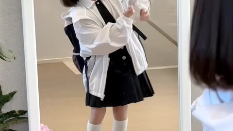 cute baby jumping in front of mirror in school outfit