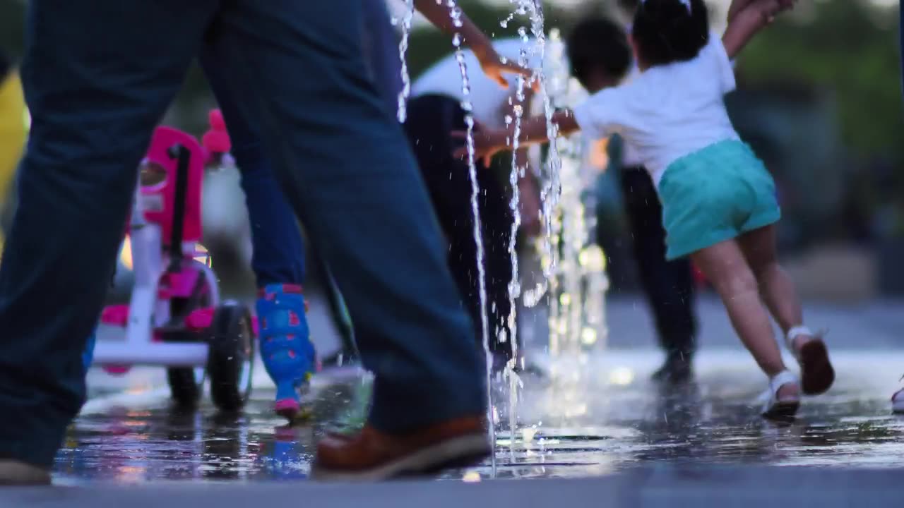 Children playing with a dancing fountain