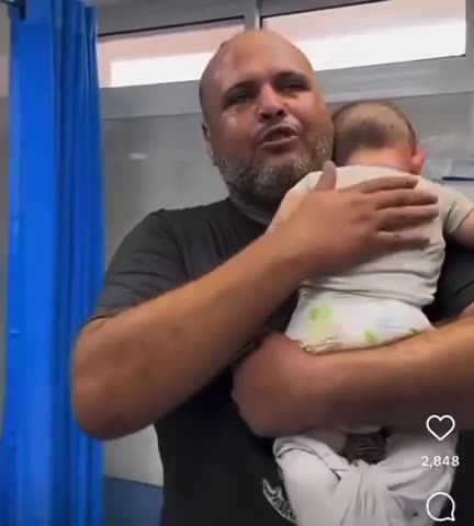 A father was filmed giving his daughter a final hug after she was killed an airstrike.