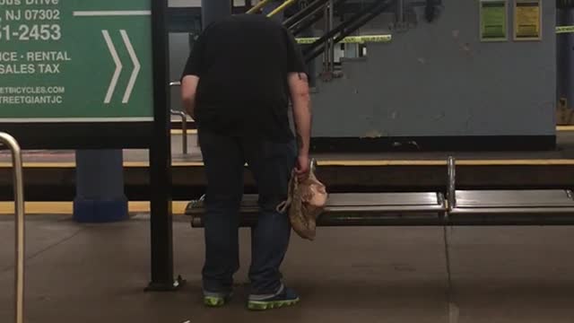 A man in black shirt slowly bending down