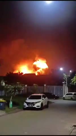 At a military base in Indonesia, a BC warehouse burns and detonates.