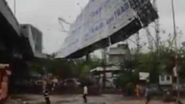 A big hoarding is totally destroyed by Cyclone in an Indian Village