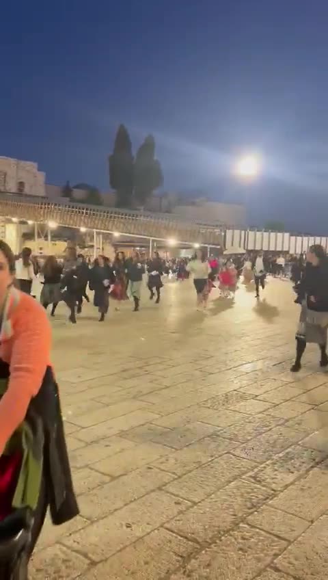 Israelis praying at the Western Wall take cover during the Hamas rocket attack against Jerusalem