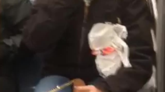 Woman puts whole fist in mouth crowded subway