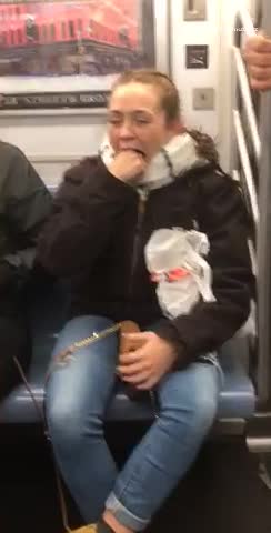 Woman puts whole fist in mouth crowded subway