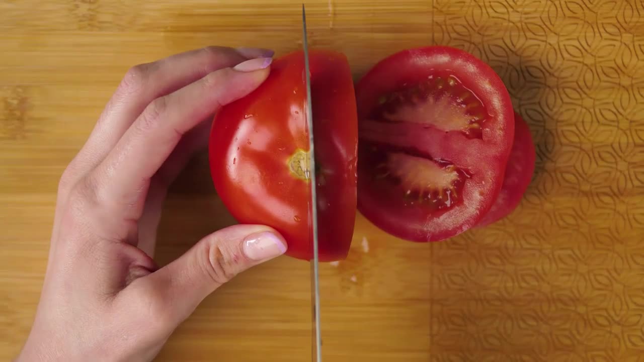 Woman slicing tomato on a board