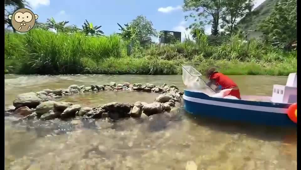 Little monkey catching fish by the river outdoors