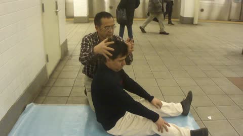 Luodong Massages Man In Black Sweater In Subway Station