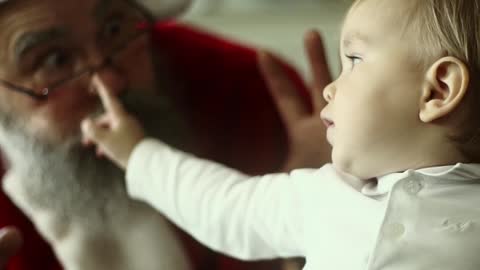 funny baby play with santa