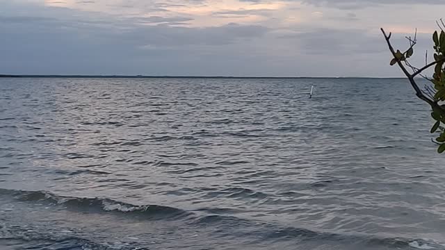 Tranquil Waves with cloudy spotted sky