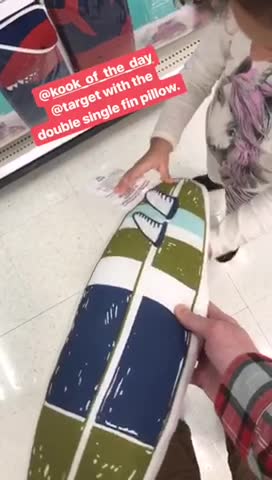 Guy holding surf pillow kid knocks it out off his hand