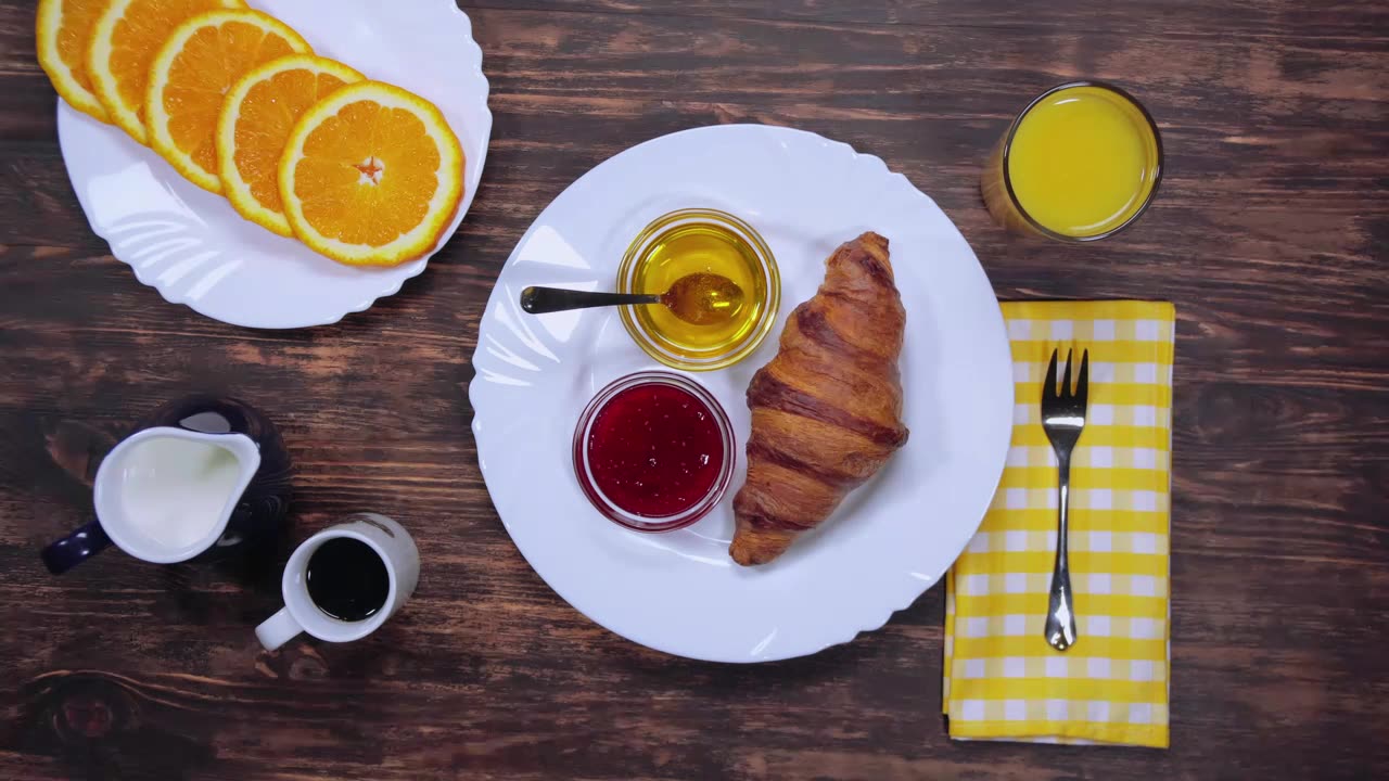 Breakfast at a table with bread, coffee and fruit