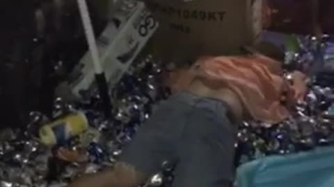 Guy pink shirt jumps into cans