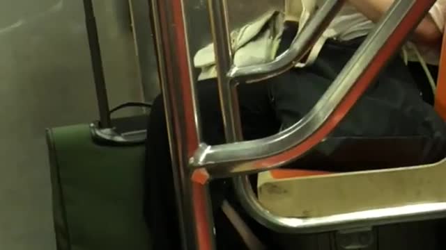 Woman goggles fixing bra on subway