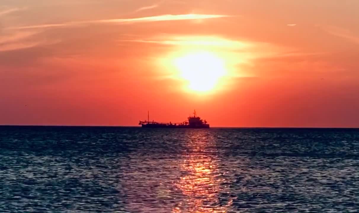 Long Shot Video of a Cargo Ship at Beautiful Sunset View