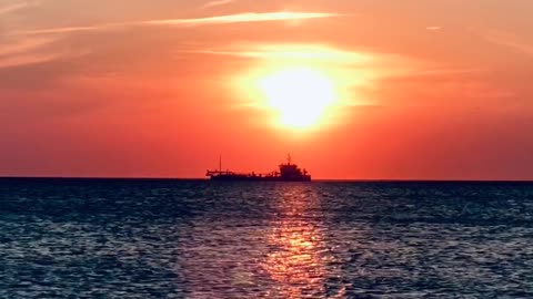 Long Shot Video of a Cargo Ship at Beautiful Sunset View