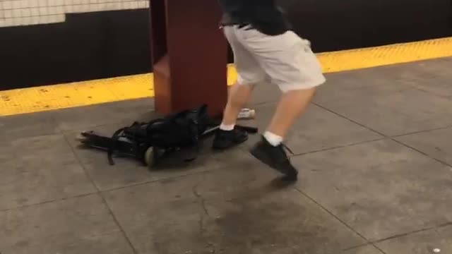 Guy white shorts black shirt karate kick subway pole