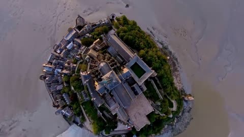 Mont Saint-Michel, a chateau on the sea, is a famous French monument and a Catholic pilgrimage site