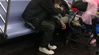 Couple smokes blunt on subway train, woman laying down on seat