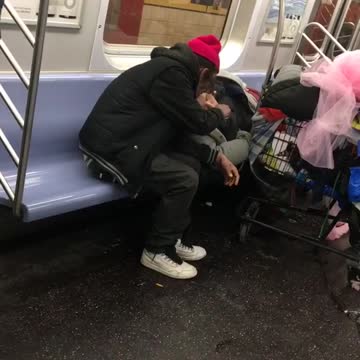 Couple smokes blunt on subway train, woman laying down on seat