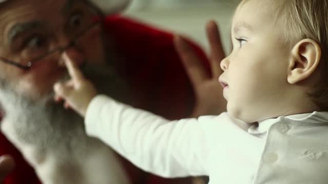 santa-claus-making-faces-with-a-baby