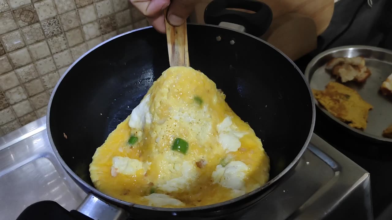 Tossing Cheese omelette during preparation