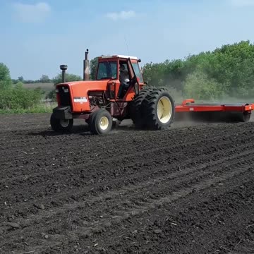 Allis Chalmers 7050 pulling a 20 foot land roller