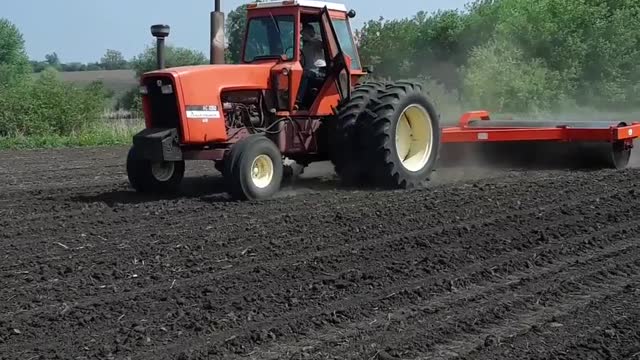 Allis Chalmers 7050 pulling a 20 foot land roller