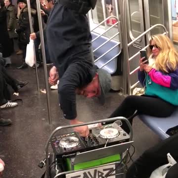 Man hangs upside down subway car with dj set