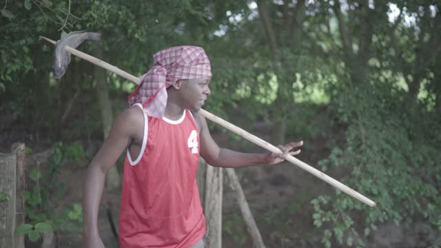 The Africa man who is a fisher man sloping down the hill after fishing in the forest