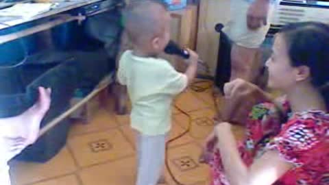 The baby is singing with his father