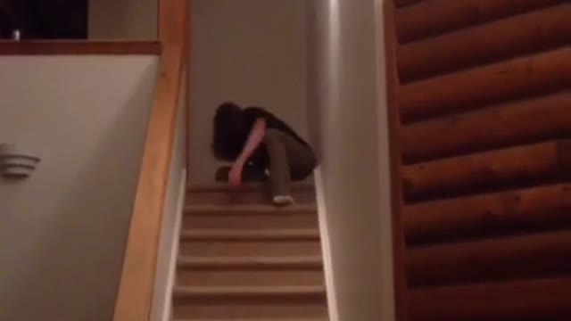 Black shirt long hair guy alex summersaults down wooden stairs