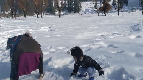 Mom and Son Play With Snow in India's Heaven on Earth at Kashmir