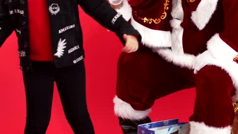 video/little-boy-posing-and-dancing-beside-santa-6212589/