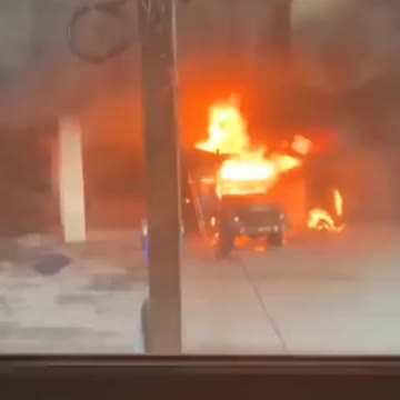 Military Infantry Vehicle Seen On Fire Outside Someone's Home