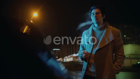 Young Stylish Man Standing Near His Car and Smoking Cigarette Outdoors