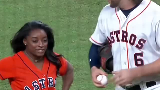 Simone Biles flips during incredible first pitch