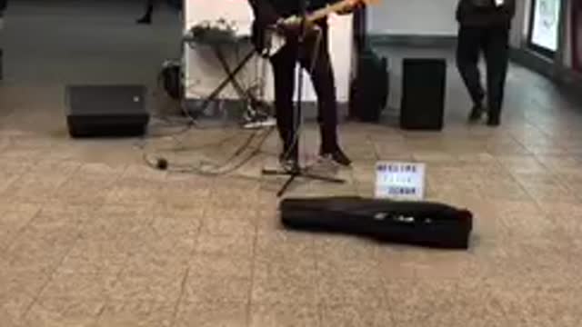 Musician playing creed in the subway station