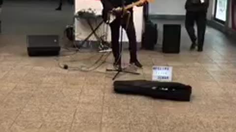 Musician playing creed in the subway station