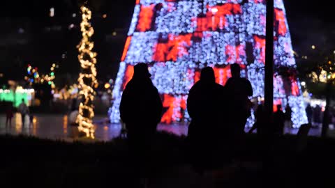 Walking near a Christmas tree outdoors